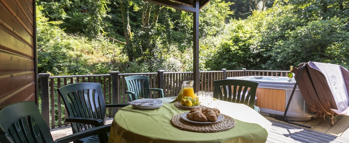 Relax in our riverside hot tub lodges